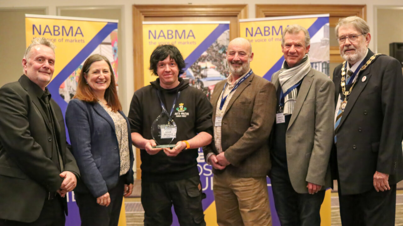 South Molton Pannier Market.

From left to right: Market Place Europe Operations Manager Andy Pidgen, MP Julia Buckley, NABMA President Councillor Chris Poulter