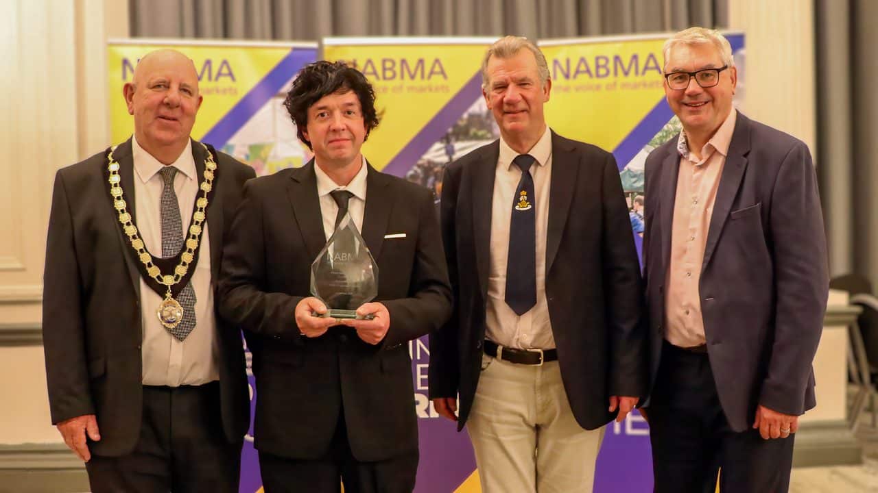 L-R: Councillor David Hopkins, President of NABMA; award winner Adam Nichols of South Molton Pannier Market, Councillor Steven Hinchliffe; and Mark Parry from ZAPP, the award sponsors.
